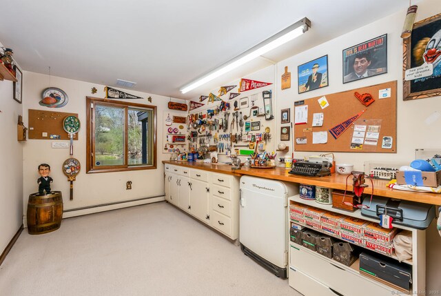 interior space featuring a baseboard heating unit, white cabinetry, and visible vents