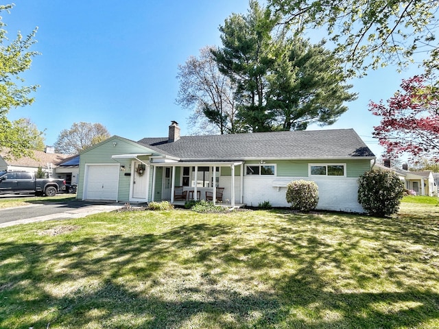 single story home with a porch, a chimney, a front yard, a garage, and aphalt driveway