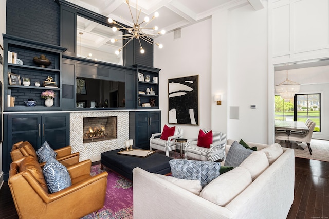 living room with dark wood-style floors, beamed ceiling, an inviting chandelier, and coffered ceiling