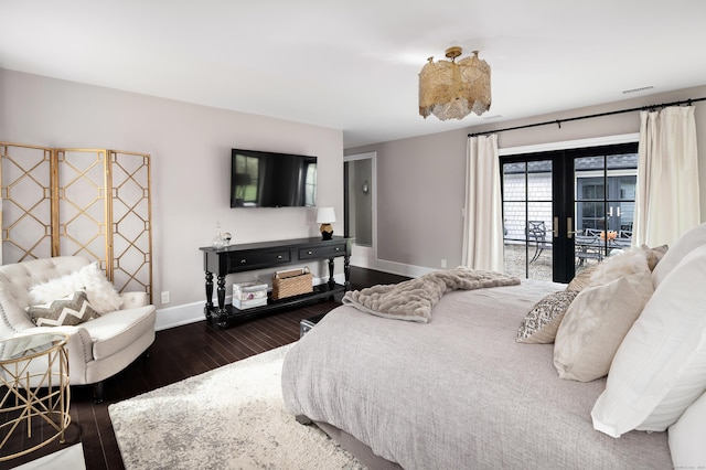 bedroom with access to exterior, visible vents, baseboards, french doors, and wood finished floors