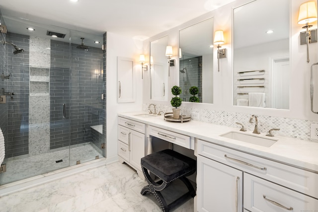 bathroom with recessed lighting, marble finish floor, a sink, and a shower stall