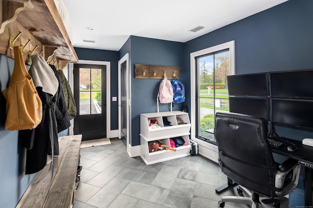 home office featuring baseboards, visible vents, and a healthy amount of sunlight