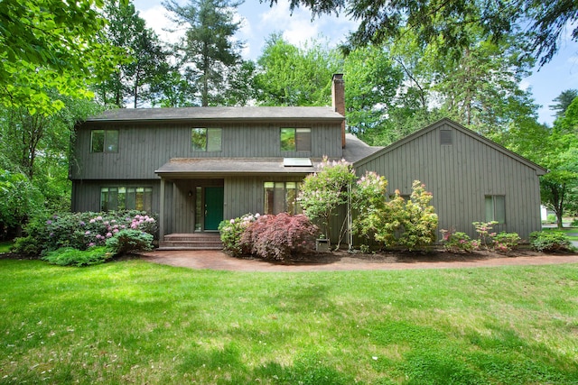 2 Trainor Dr, Simsbury, CT 06089 - rear view of house featuring a chimney and a yard