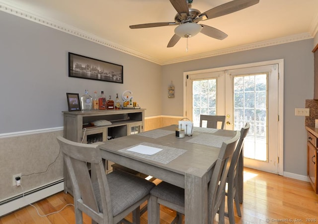 dining area with a ceiling fan, french doors, a baseboard radiator, light wood finished floors, and ornamental molding