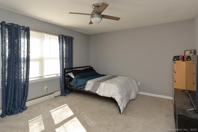 bedroom with baseboards, carpet flooring, a ceiling fan, and a baseboard heating unit