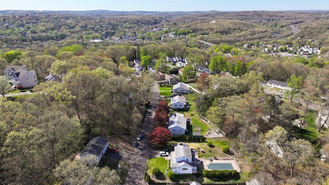 birds eye view of property with a view of trees