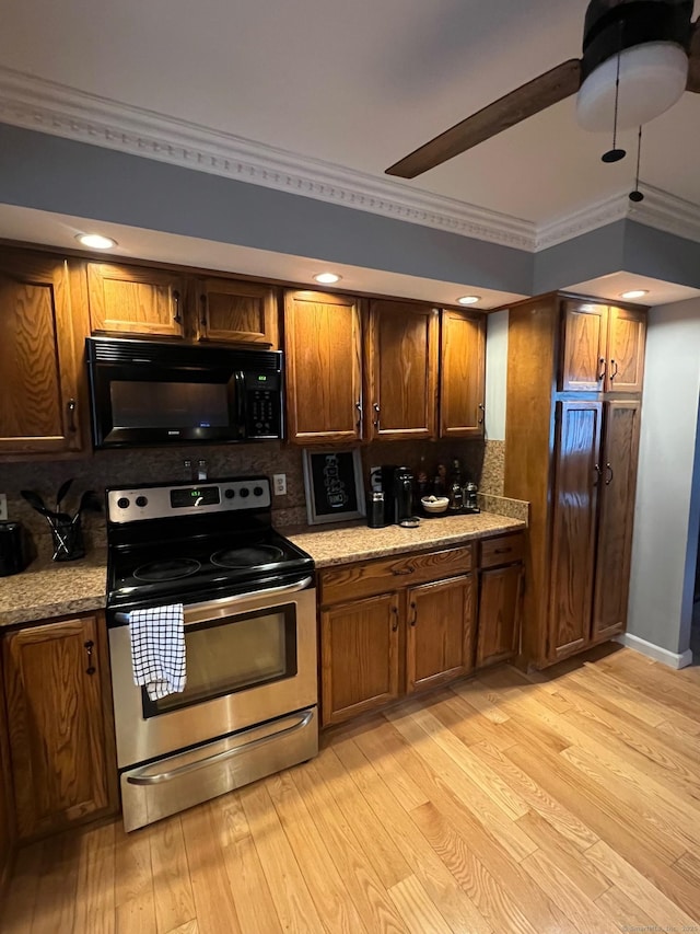 kitchen featuring black microwave, light wood-style flooring, electric stove, decorative backsplash, and ornamental molding