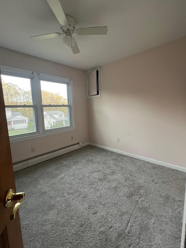 carpeted empty room with baseboards, a ceiling fan, and baseboard heating