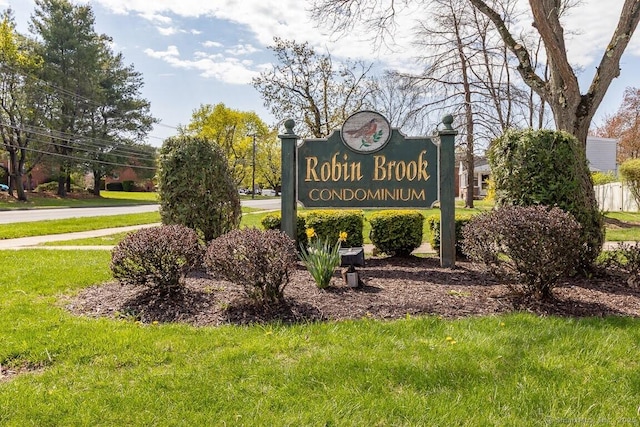 community / neighborhood sign with a lawn