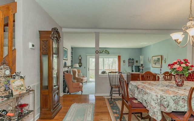 dining area with a chandelier and wood finished floors