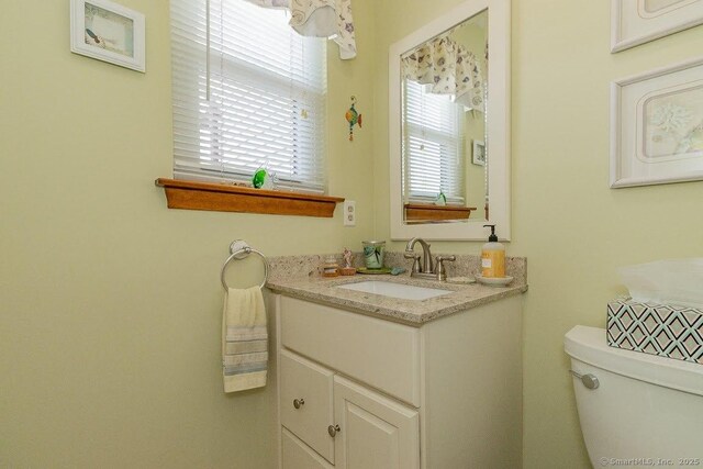 bathroom featuring toilet and vanity