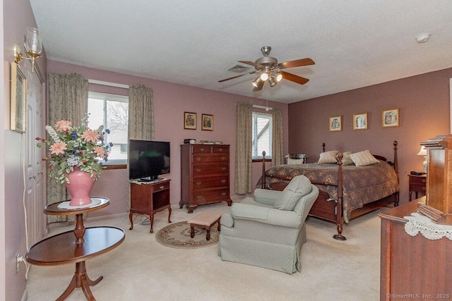 bedroom with visible vents, ceiling fan, baseboards, and carpet floors