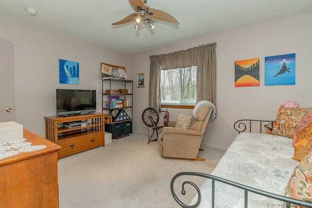 living area featuring carpet and a ceiling fan