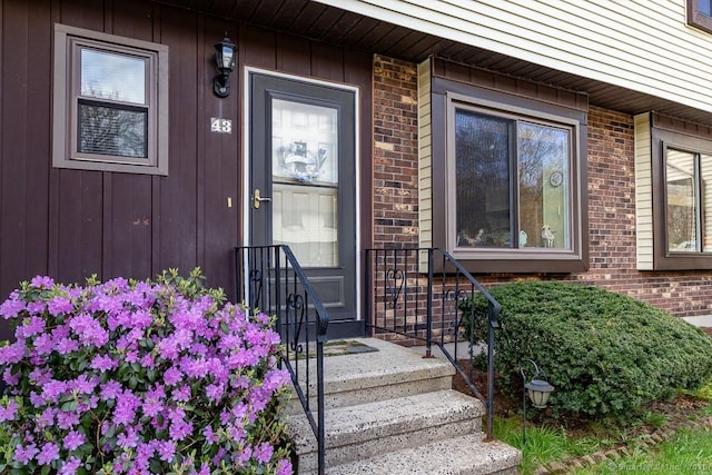 property entrance with brick siding