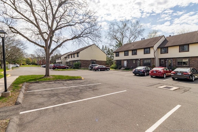 uncovered parking lot featuring a residential view