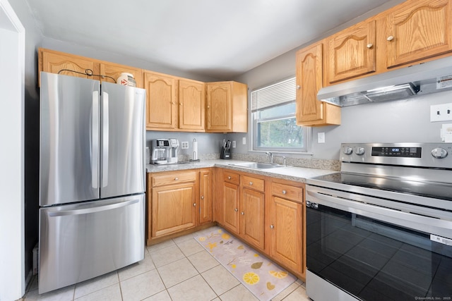 kitchen with light tile patterned flooring, a sink, light countertops, stainless steel appliances, and under cabinet range hood