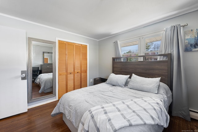 bedroom with ornamental molding, wood finished floors, and a closet