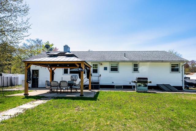 back of house featuring fence, a patio, a gazebo, and a yard