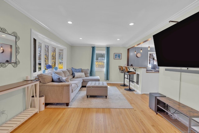 living room featuring ornamental molding, recessed lighting, and wood finished floors