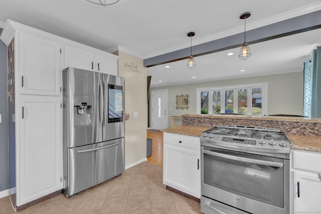 kitchen with white cabinetry, stainless steel appliances, crown molding, and baseboards