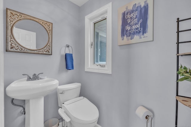 bathroom with toilet and a sink