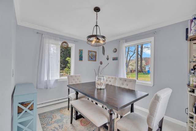 dining room with a baseboard radiator, crown molding, and baseboards