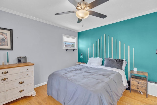bedroom featuring ceiling fan, crown molding, and light wood finished floors