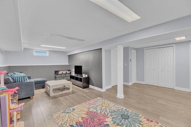 living area featuring light wood finished floors and baseboards