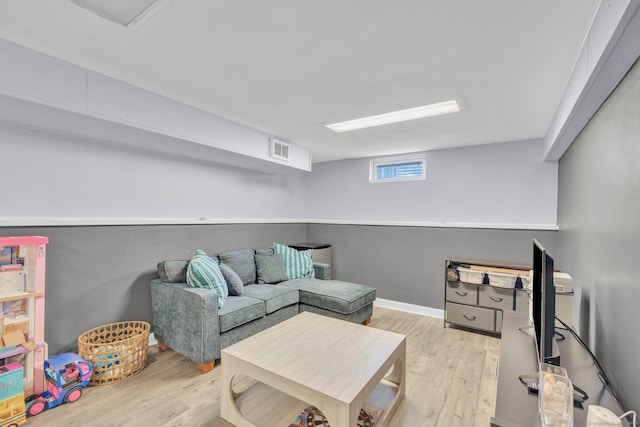 living room featuring visible vents, wood finished floors, and baseboards