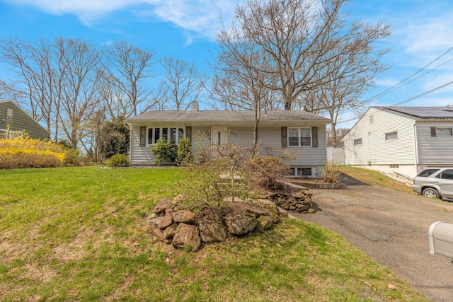 view of front of home featuring a chimney and a front yard