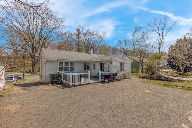 back of house with a chimney, an outdoor hangout area, and a wooden deck