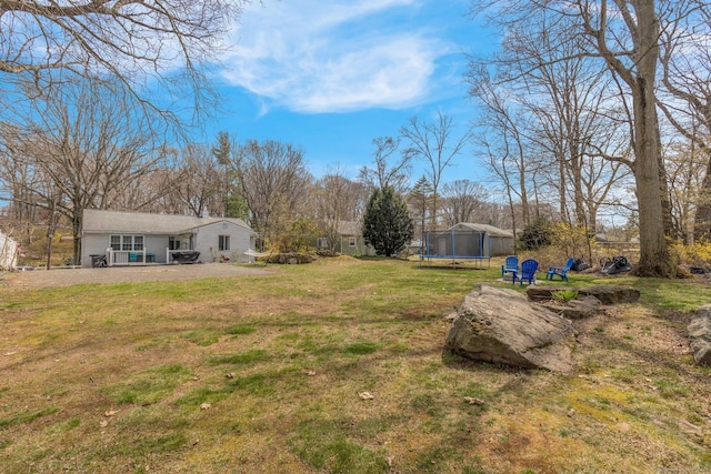 view of yard with a trampoline