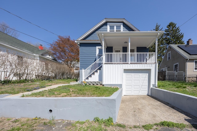 bungalow-style house featuring driveway, stairway, fence, and a porch