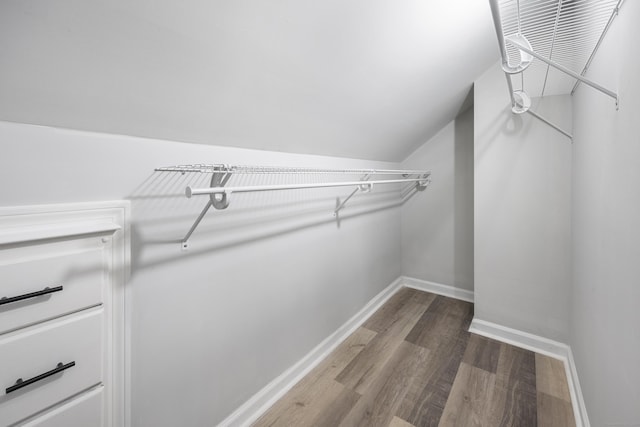 spacious closet with wood finished floors and lofted ceiling