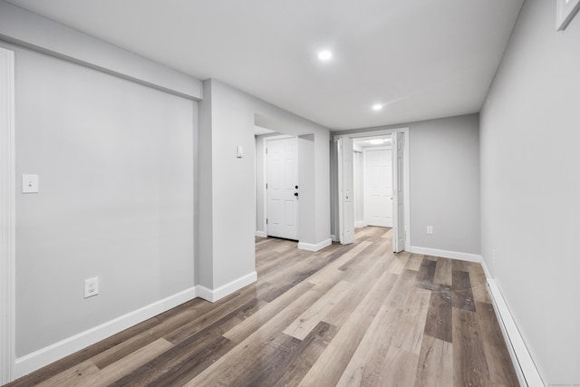 finished basement featuring recessed lighting, wood finished floors, and baseboards