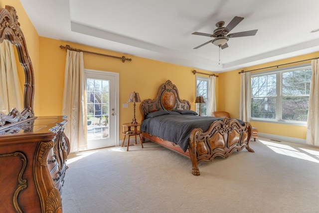 6 Holdridge Ct, Groton, CT 06355 - carpeted bedroom with access to exterior, multiple windows, and a raised ceiling