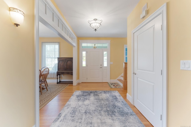 6 Holdridge Ct, Groton, CT 06355 - foyer entrance with an inviting chandelier, light wood-style floors, and baseboards