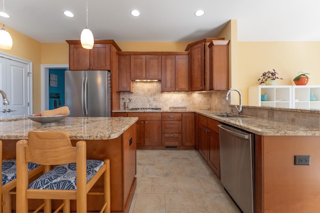 6 Holdridge Ct, Groton, CT 06355 - kitchen with brown cabinets, stainless steel appliances, a kitchen bar, and a sink