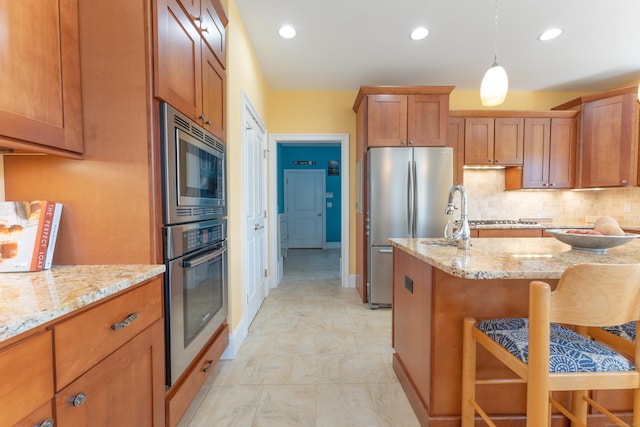 6 Holdridge Ct, Groton, CT 06355 - kitchen featuring appliances with stainless steel finishes, a breakfast bar, and brown cabinets