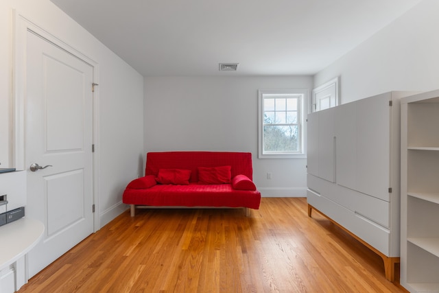 6 Holdridge Ct, Groton, CT 06355 - living area with visible vents, light wood-type flooring, and baseboards