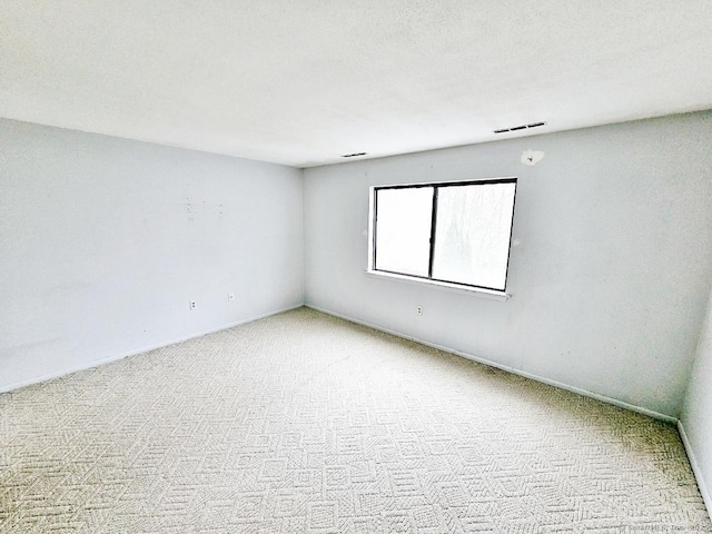 empty room featuring carpet flooring