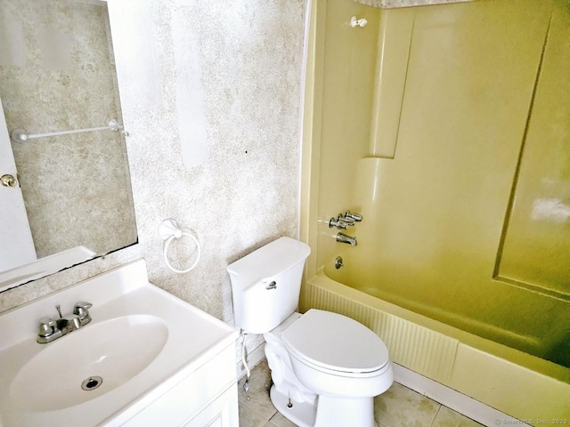 bathroom featuring tile patterned floors, toilet, vanity, and bathtub / shower combination