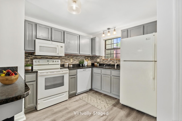 268 Lawlor St Apt 6, New Britain, CT 06051 - kitchen with white appliances, gray cabinetry, dark countertops, and tasteful backsplash