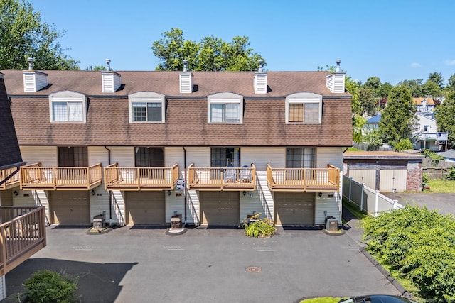 268 Lawlor St Apt 6, New Britain, CT 06051 - back of house with a shingled roof, an attached garage, a chimney, and driveway