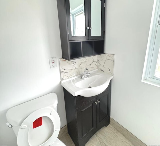 4 Culver Ct, Naugatuck, CT 06770 - half bath with vanity, toilet, and tasteful backsplash
