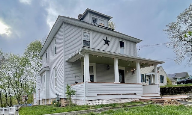 american foursquare style home with covered porch