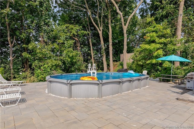 outdoor pool with area for grilling