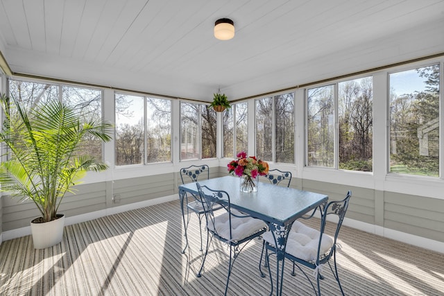 sunroom featuring outdoor dining area
