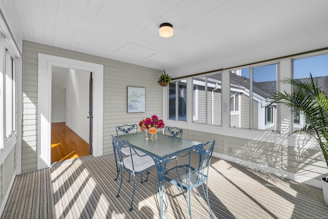 sunroom / solarium with outdoor dining space
