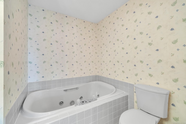 bathroom with toilet, a whirlpool tub, and wallpapered walls
